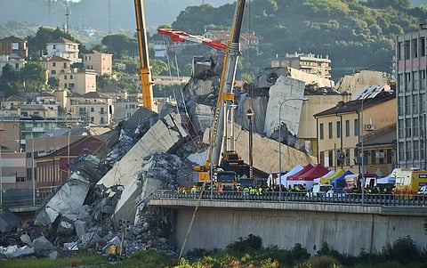 Rescuers search the crumbled hulk of the collapsed Morandi highway bridge in Genoa, northern Italy, Wednesday. ( Photo | AP)