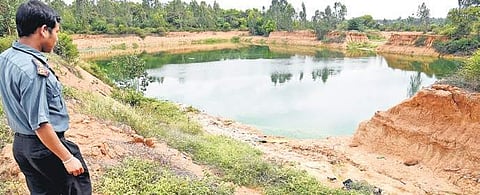 A security guard shows a small water body in Mandur which till recently was emanating a stench due to garbage dumping in the area | nagaraja gadekal