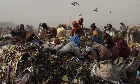 Volunteers cleaning the waste material that being dumped at Ghazipur landfill at New Delhi. (Photo | File/EPS)