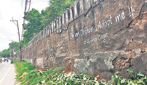 Heritage structures in Cyberabad are not well maintained - a neglected and old wall in Raidurgam saying ‘adopt me’. (top) An aerial view of Gachibowli (Photo| R Satish Babu/EPS)