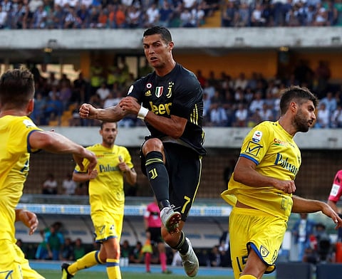Juventus' Cristiano Ronaldo jumps as he reaches for the ball during the Serie A match against Chievo | AP