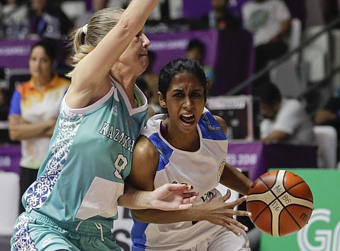 India's Prasannan Geetha, right, drives to the basket against Kazakhstan's Mariya Astapenko during their women's basketball match at the 18th Asian Games in Jakarta. (Photo | AP)