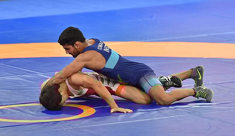 India's wrestler Sandeep Tomar with Turkmenistan's Rustem Nazarov in the men's freestyle wrestling 57kg qualification round at the Asian Games 2018 in Jakarta on Sunday August 19 2018. (Photo | AP)
