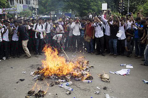 Bangladeshi students burn an effigy of Bangladesh's Shipping Minister Shahjahan Khan, who is also a transport workers' leader, as they block a road during a protest in Dhaka, Bangladesh, Wednesday, Aug. 1, 2018. (Photo | AP)
