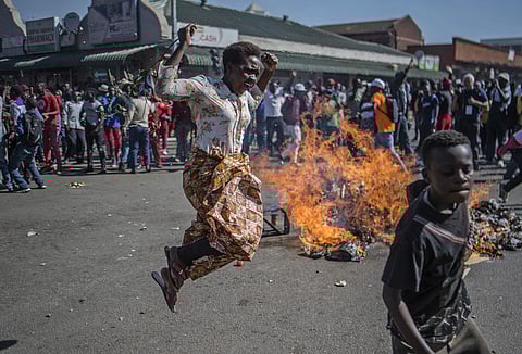 Opposition MDC party supporters protest in the streets of Harare during clashes with police Wednesday, Aug. 1, 2018. (Photo | AP)