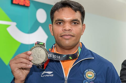 Indian shooter Deepak Kumar poses with his silver medal during the medal ceremony for the 10m Air Rifle Men's event during the 18th Asian Games Jakarta Palembang 2018 in Indonesia on Monday Aug 20 2018. | PTI
