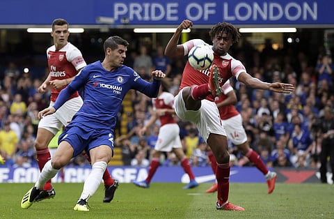 Arsenal's Alex Iwobi, right, fights for the ball with Chelsea's Alvaro Morata during the English Premier League soccer match between Chelsea and Arsenal at Stamford bridge stadium in London, Saturday, Aug. 18, 2018. | AP