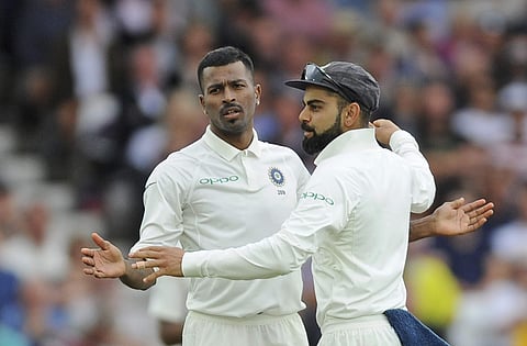 Indian captain Virat Kohli, right, congratulates teammate Hardik Pandya for the dismissal of England's Adil Rashid during the second day of the third Test match between England and India at Trent Bridge in Nottingham, England, Sunday, Aug. 19, 2018. | AP