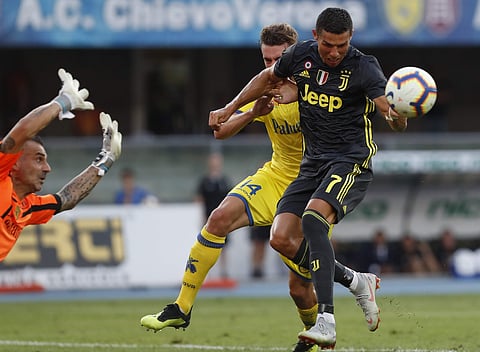 Juventus' Cristiano Ronaldo goes for the ball during the Serie A soccer match between Chievo Verona and Juventus, at the Bentegodi Stadium in Verona, Italy, Saturday, Aug. 18, 2018. | AP