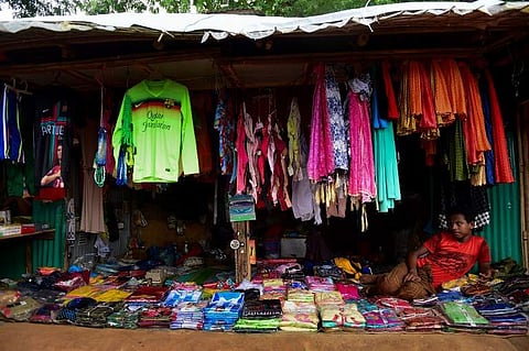 A Rohingya refugee looks on while displaying replica jerseys of the national football teams of Argentina, Brazil and Portugal at a shop in Kutupalong refugee camp in Ukhia. (Photo | AFP)