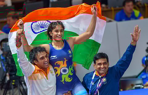 Vinesh Phogat celebrates with the Tricolour after winning the Gold medal in women's freestyle 50 kg wrestling at the Asian Games 2018 in Jakarta. (Photo | PTI)