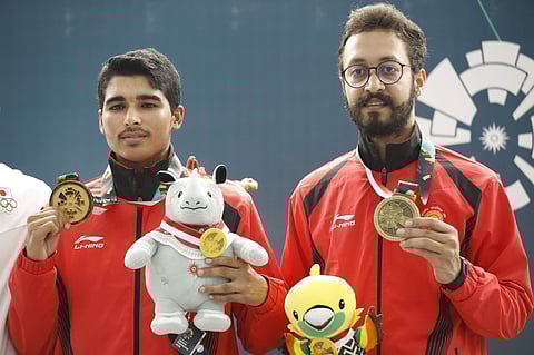 Bronze medalist India's Abhishek Verma, right, and gold medalist India's Saurabh Chaudhary, pose after the 10m air pistol men's final shooting event during the 18th Asian Games in Palembang, Indonesia. (Photo | AP)