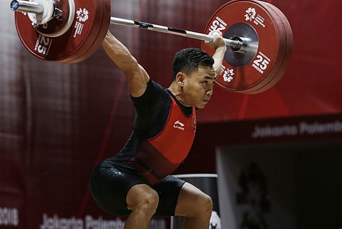 Indonesia's Eko Irawan attempts during the men's 62 kg weightlifting at the 18th Asian Games in Jakarta, Indonesia, Tuesday, Aug. 21, 2018. | AP