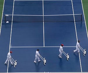 Workers squeegee the main court in Arthur Ashe Stadium prior to the start of play at the US Open tournament in New York. (File | AP)