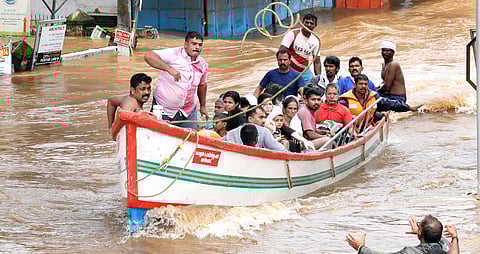 Fishermen assist rescue operations in small fishing boats at Thottumugham near Aluva (Photo | EPS/Melton Antony)