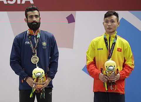 Bronze medalist India's Surya Singh, left, and bronze medalist Vietnam's Truong Giang Bui during ceremonies at the wushu men's Sanda 60kg division at the 18th Asian Games in Jakarta, Indonesia, Thursday, Aug. 23, 2018. | AP