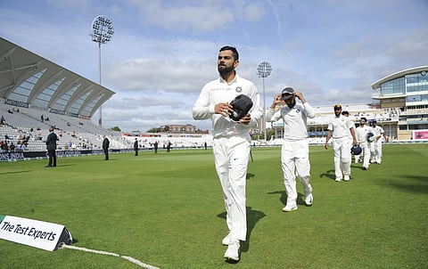 Indian captain Virat Kohli leads his team off the field after their victory over England by 203 runs in the third Test match at Trent Bridge in Nottingham, England, Wednesday, Aug. 22, 2018. | AP