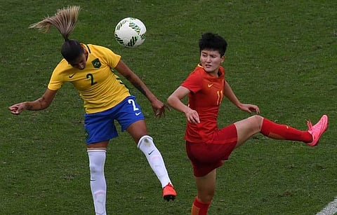 Brazilian player Fabiana (L) heads the ball marked by China player Wang Shanshan during the Rio 2016 Olympic Games women’s first round Group E football match Brazil vs China, at the Olympic Stadium in Rio de Janeiro, Brazil on August 3, 2016. | (File | AF