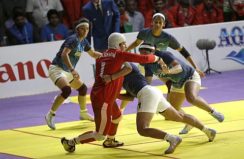 Iran's Ghazal Khalal, in red, tries to score a point agaisnt India's team during the women's team Kabaddi gold medal match at the 18th Asian Games. (Photo | AP)