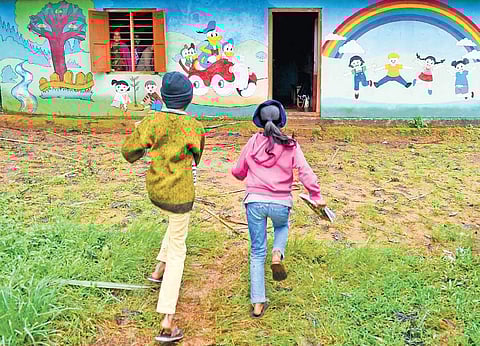Children rush towards a government school in Mekkeri which was opened after a long break post landslides | pushkar V