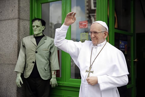 A recently unveiled waxwork statue of Pope Francis is displayed next to a Frankenstein figure outside the National Wax Museum in Dublin, Ireland. (Photo | AP)