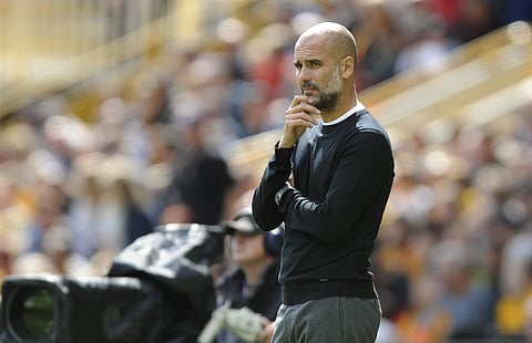 Manchester City coach Pep Guardiola stands by the bench during the English Premier League soccer match against Wolverhampton | AP