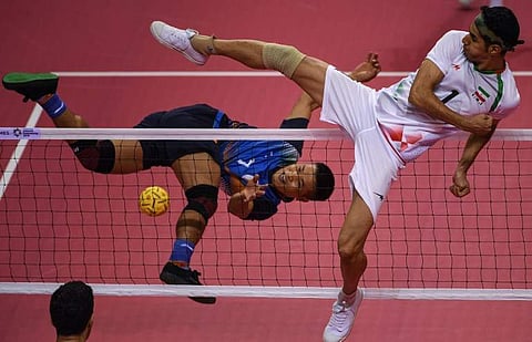 India's Thokchom Seitaram Singh (L) jumps for the ball against Iran's Jafari Mehrdad during the sepak takraw men's team regu match during the 2018 Asian Games. (File Photo | AFP)