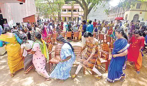 Women particpating in a musical chair competition as part of the Onam celebrations at the Maharaja's College relief camp in Kochi | Express