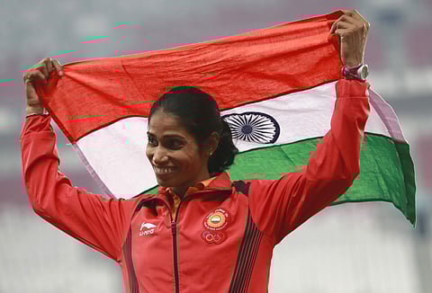 Women's 3000m steeplechase silver medalist India's Sudha Singh stands on the podium during the athletics competition at the 18th Asian Games in Jakarta. (Photo | AP)