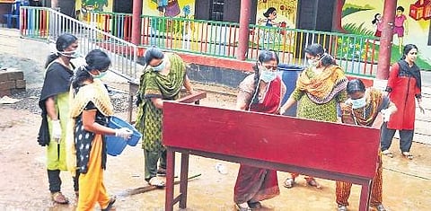 A group of teachers from Govt HSS Maneed engaged in cleaning at Eloor Vadakkumbhagom, SHJ UP School premises on Wednesday. The school was nearly submerged during the floods