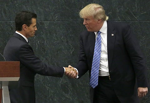 Mexico's President Enrique Pena Nieto, left, and Republican presidential nominee Donald Trump shake hands after a joint statement in Mexico City. (Photo | AP)