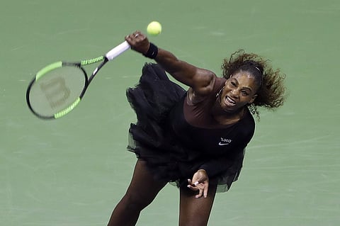 Serena Williams serves to Magda Linette during the first round of the US Open tennis tournament. | AP