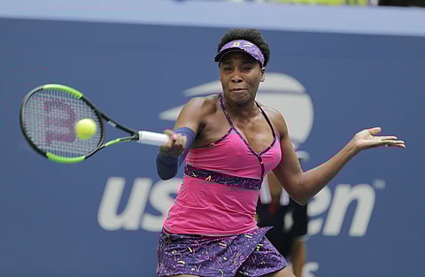 Venus Williams returns a shot to Svetlana Kuznetsova during the first round of the US Open tennis tournament. | AP