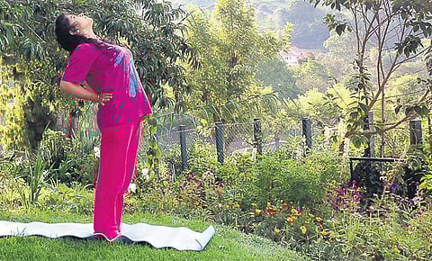 Practice Ardhachakrasan for a good posture