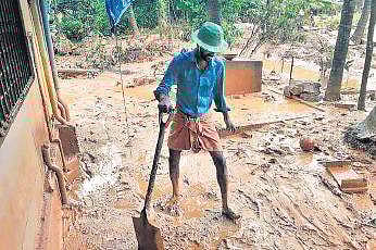 A volunteer engaged in cleaning after the floods