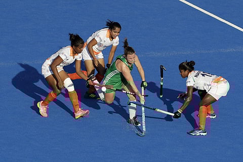 Ireland's Lizzie Colvin, center, tries to get through India players during the Women's Hockey World Cup quarterfinal match between India and Ireland at the Lee Valley Hockey and Tennis Centre in London. (Photo | AP)