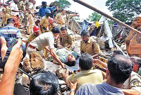 A man rescued from the debris being shifted on a stretcher by the police and fire force personnel on Thursday | Express