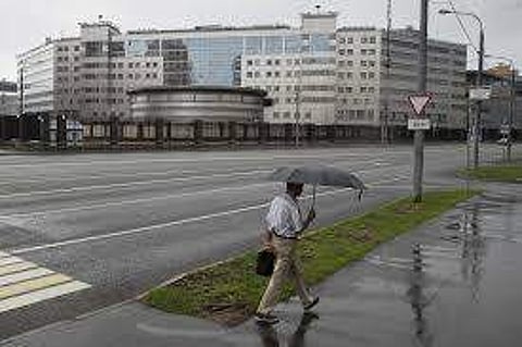 A man walks past the building of the Russian military intelligence service in Moscow, Russia. (Photo | AP)