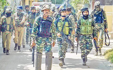 Security personnel take position near a house where militants were hiding during an encounter in which the top Hizbul Mujahideen militant, Altaf Ahmad Dar, and his associate Umar Rashid were killed, at Muniward in Anantnag district (Photo | PTI)