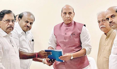 Chief Minister H D Kumaraswamy submits a memorandum to Union Home Minister Rajnath Singh seeking relief funds from Centre. Deputy CM G Parameshwara, Ministers R V Deshpande and Bandeppa Kashempur were also present