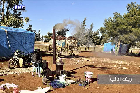 A displaced Syrian man and boy, who fled from an under-attack countryside village of Idlib city sits outside their tent at an informal refugee camp. (Photo | AP)