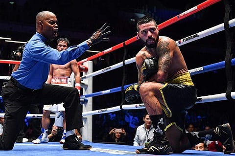 The referee counts after Philippines' Manny Pacquiao knocked down Argentina's Lucas Matthysse (R) during their world welterweight boxing championship bout at Axiata Arena in Kuala Lumpur on July 15, 2018. (File | AFP)