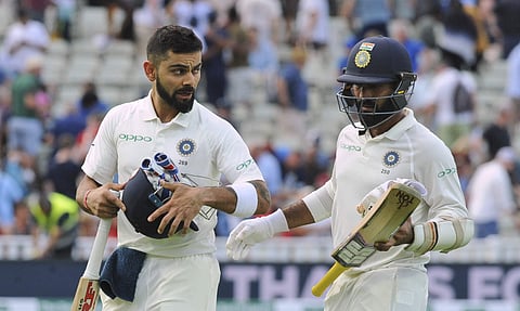 Indian cricket captain Virat Kohli, left, and Dinesh Karthik leave the field at the end of the day's play on the third day of the first test cricket match between England and India at Edgbaston in Birmingham. (Photo | AP)