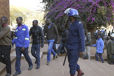 Opposition party supporters arrested during a raid at the party headquarters appear at the magistrates court in Harare. (Photo | AP)