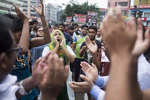 Bangladeshi students shout slogans as they block a road during a protest in Dhaka, Bangladesh. (Photo | AP)