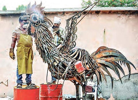 Artists busy in making scrap scluptures during the National Scrap Sculpture camp at VMC Vehicle Depot in Vijayawada (File Photo) | P Ravindra Babu