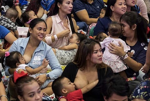 About 1,500 women, some of them wearing tiaras and superhero T-shirts, sat on the vast floor of a Manila stadium and let their babies suckle to the beat of dance music. (Photo | AFP)