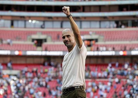 Manchester City's manager Pep Guardiola celebrates after they won the Community Shield soccer match between Chelsea and Manchester City at Wembley, London, Sunday, Aug. 5, 2018. | AP