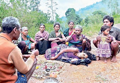 The head of D Sampalli, a tribal hamlet, performs a puja to ascertain whether the ailing 45-year-old Lingamma will survive or not, in Paderu mandal in Visakhapatnam district on Saturday. Residents of several tribal villages turn to faith healers due to la