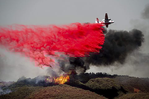 an air tanker drops retardant on a wildfire burning near Lakeport, Calif. (Photo | AP)